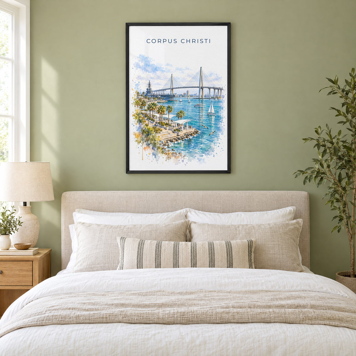 Corpus Christi watercolor print in a black frame above an upholstered headboard in a sage green bedroom