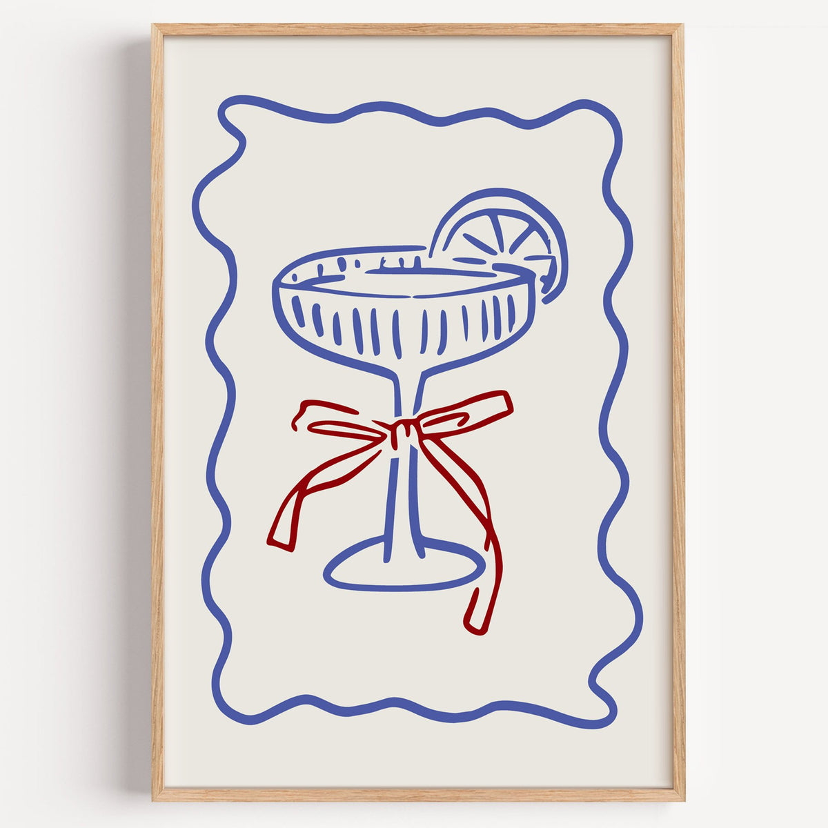 Blue coupe glass with red bow print in a light oak frame on a plain white wall