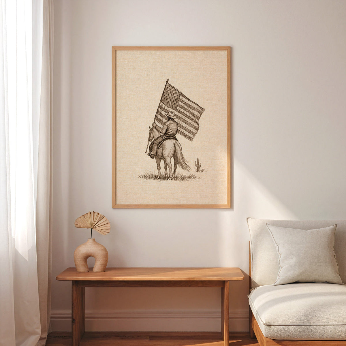 Cowboy American flag print in an oak frame above a console with an arch vase