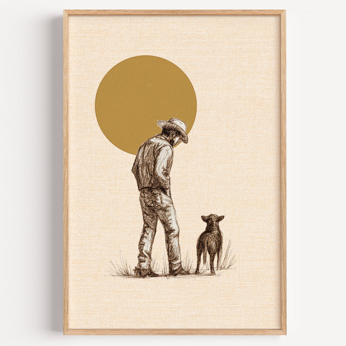 Cowboy and his dog golden sun print in a light oak frame on a plain white wall