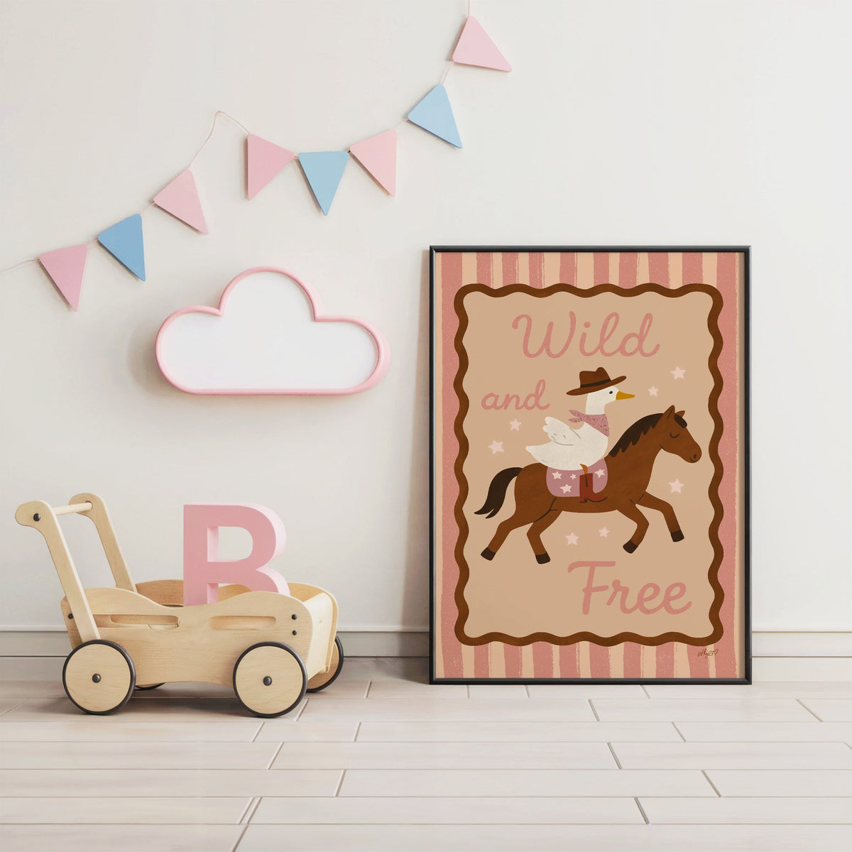 Cowboy goose riding a brown horse nursery print in a black frame under pastel bunting by a wooden baby walker