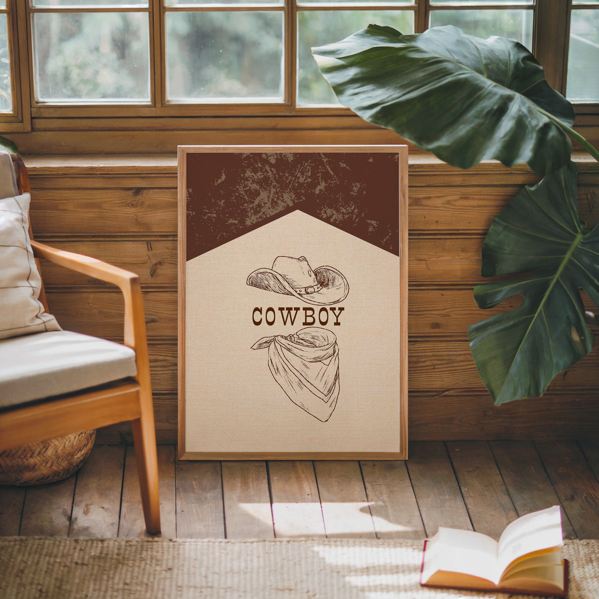 Cowboy hat and bandana print in an oak frame against a wood panel cabin wall