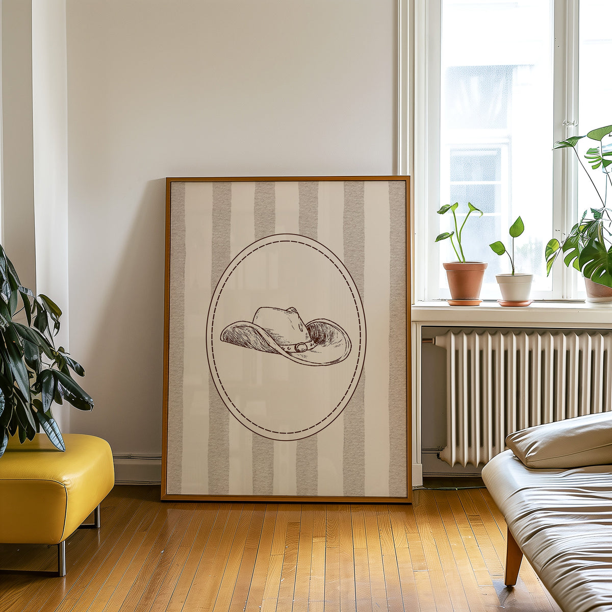 Cowboy hat cameo print in an oak frame on a parquet floor beside a yellow bench
