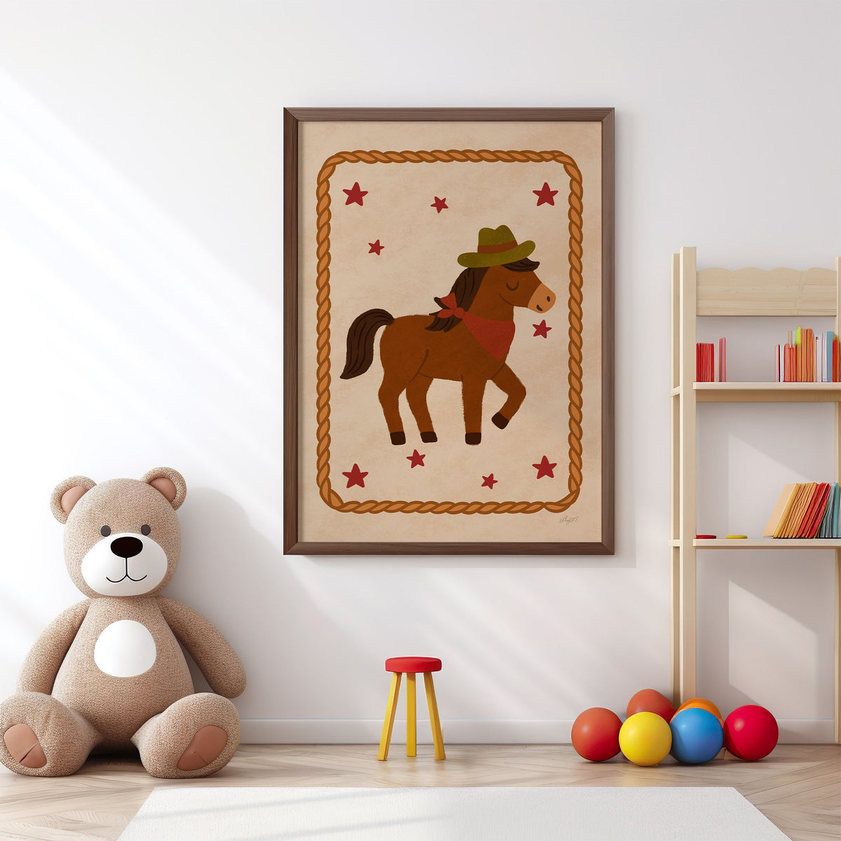 Cowboy pony in rope frame nursery print in a walnut frame above a big teddy bear by a bookshelf
