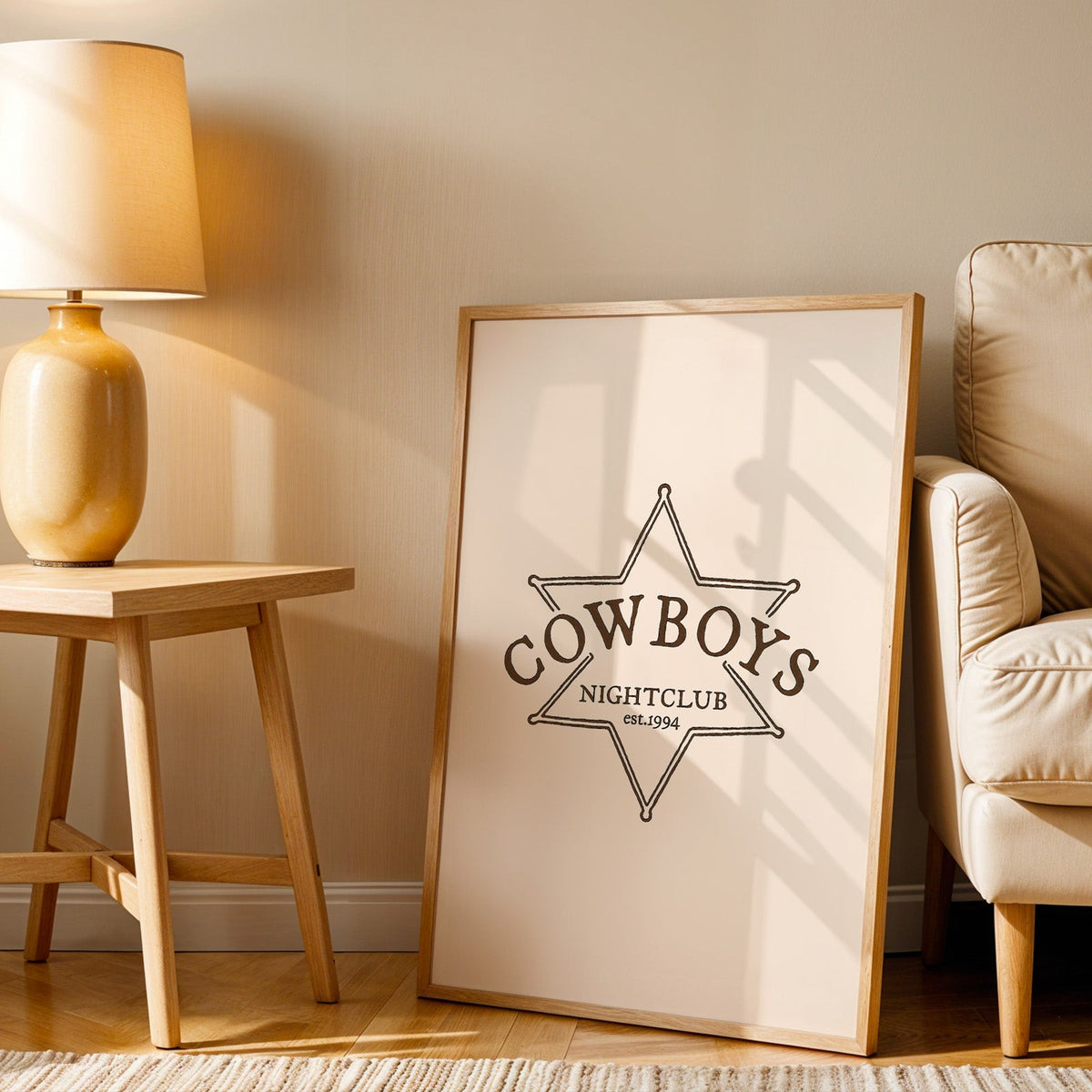 Cowboys Nightclub star print in an oak frame beside an amber ceramic lamp
