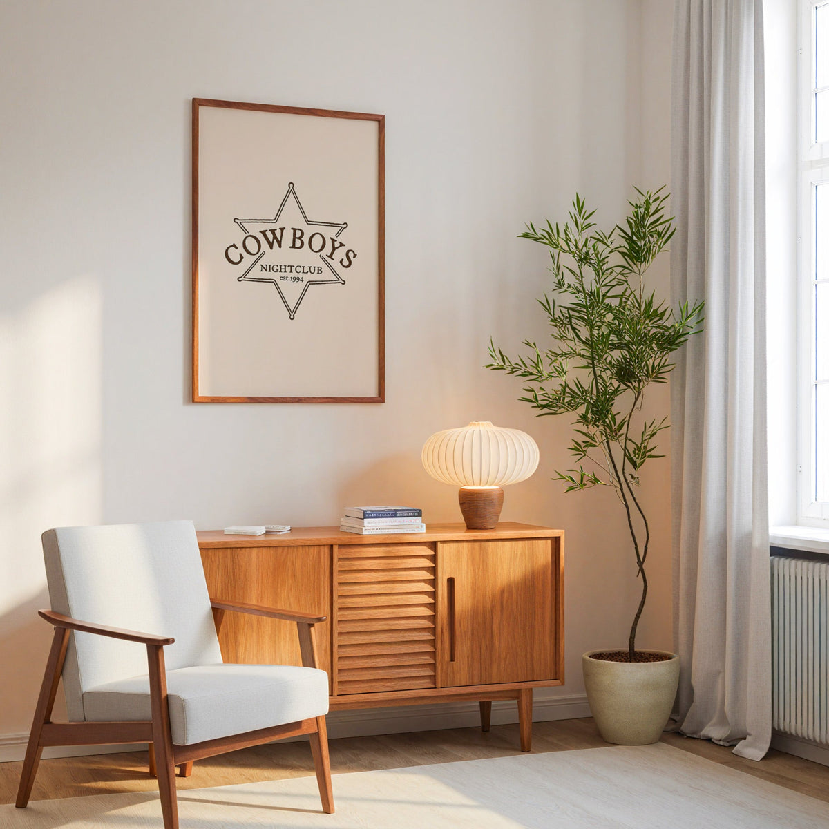 Cowboys Nightclub star print in an oak frame above a mid-century sideboard