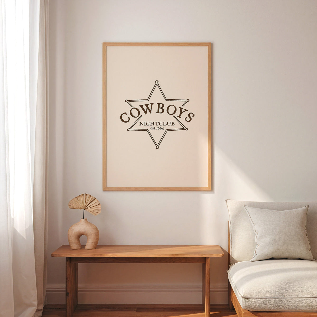 Cowboys Nightclub star print in an oak frame above a console with an arch vase