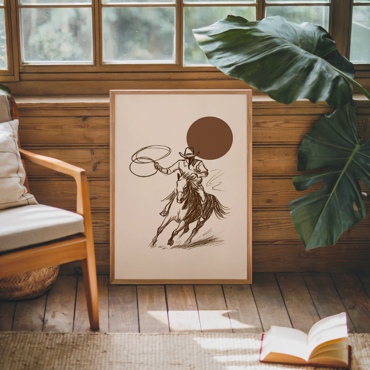 Cowgirl galloping horse print in an oak frame against a wood panel cabin wall