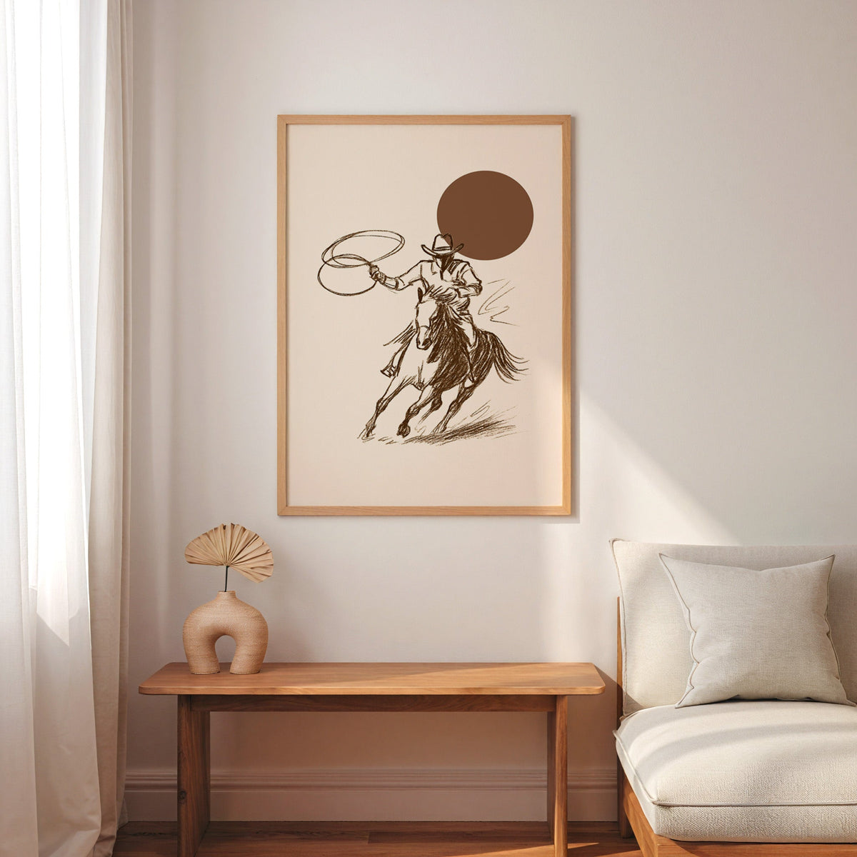 Cowgirl galloping horse print in an oak frame above a console with an arch vase