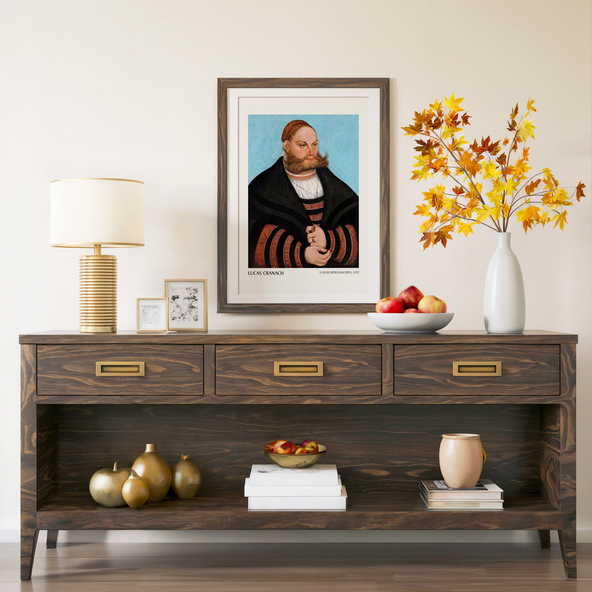 Lukas Spielhausen 1532 print in a walnut frame above a console with autumn branches