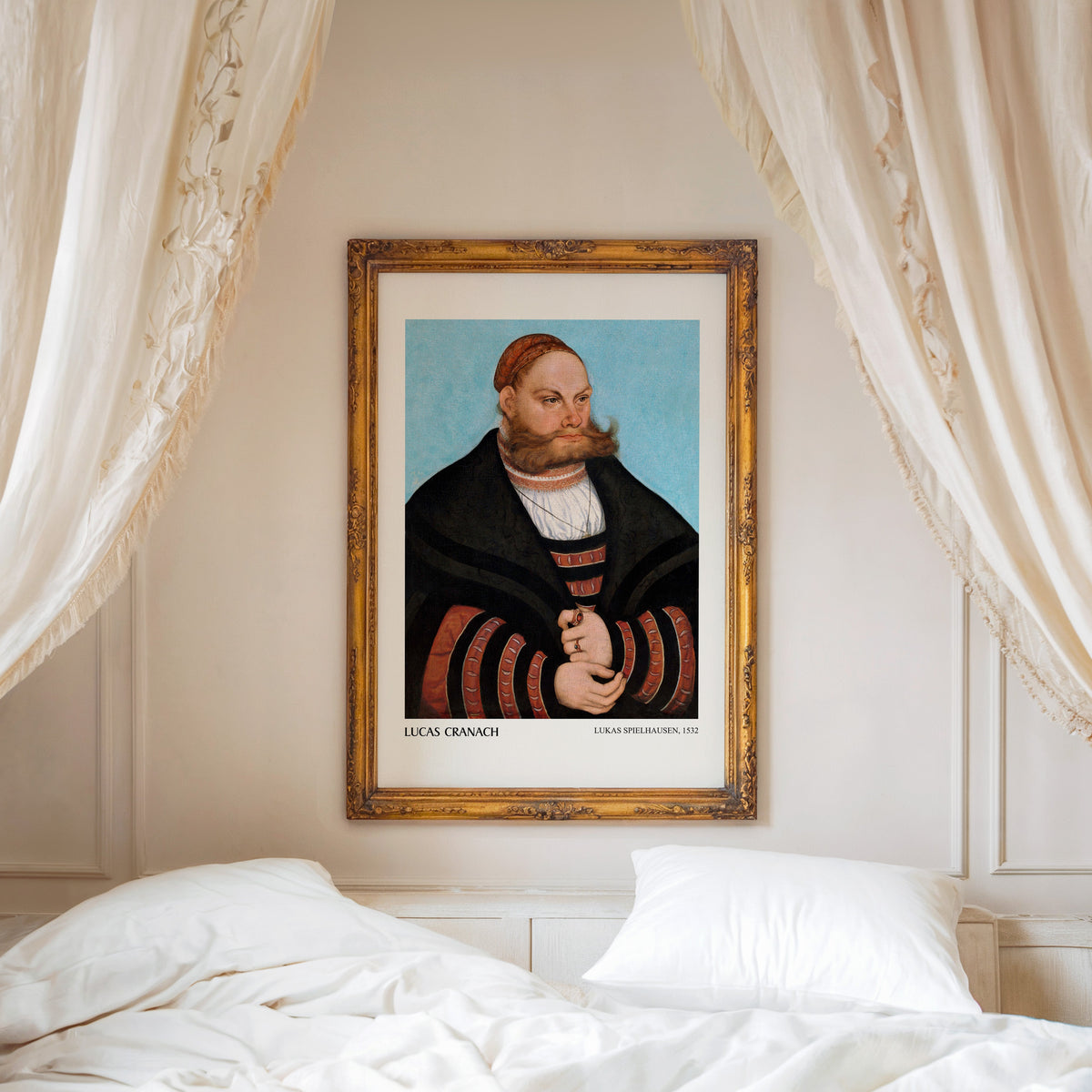 Blue-ground portrait print shown in an ornate gold frame above a canopy bed