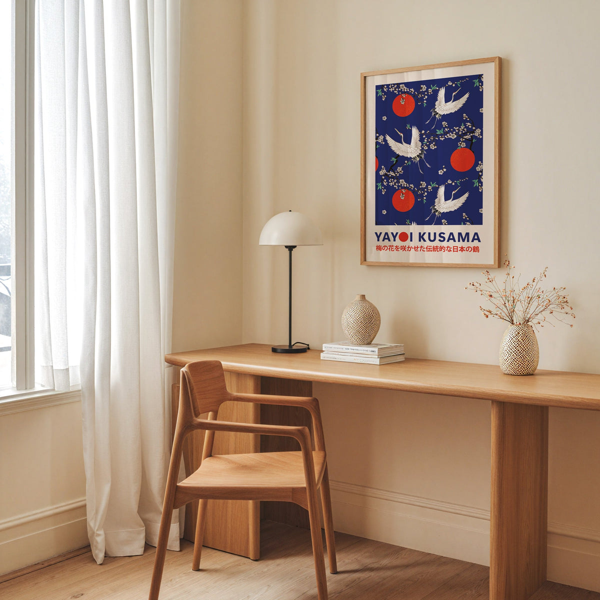 Yayoi Kusama inspired cranes and plum blossom on cobalt print in an oak frame above an oak desk with a dome lamp