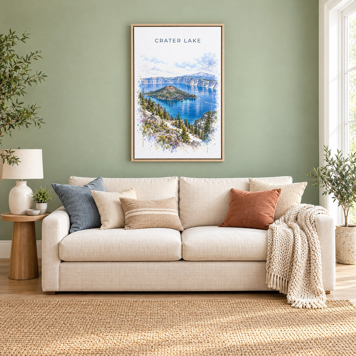 Crater Lake National Park watercolor print as a natural floater canvas above a cream linen sofa on a sage green wall