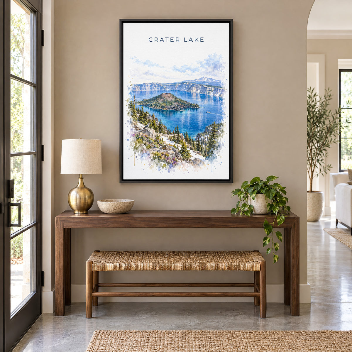 Crater Lake National Park watercolor print as a black floater canvas above a walnut console and woven bench in an entryway