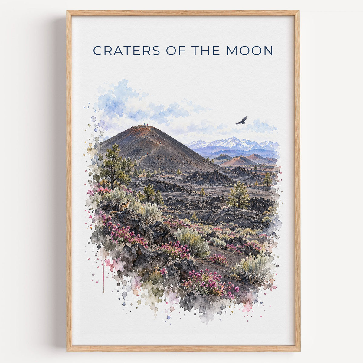 Craters of the Moon National Monument watercolor print in a light oak frame on a plain white wall