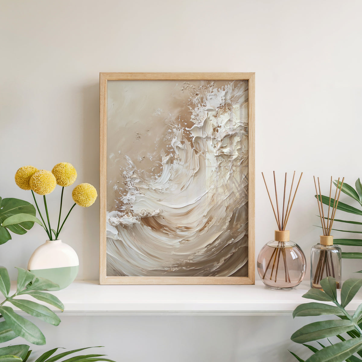 Cream and beige impasto wave abstract print in a light oak frame leaning on a white mantel with yellow flowers