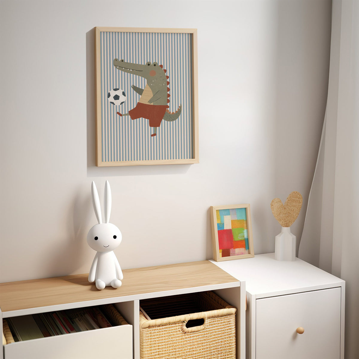 Crocodile soccer ball nursery print in an oak frame above a kids cubby shelf with a woven basket and bunny lamp