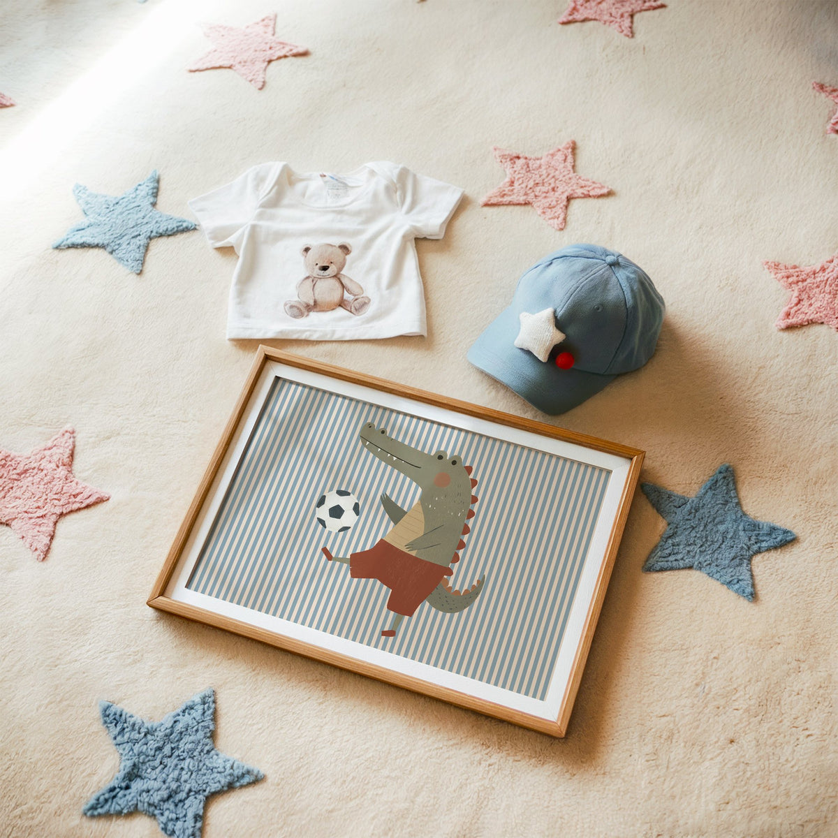 Landscape crocodile soccer ball nursery print in a matted oak frame on a star rug with a baby tee