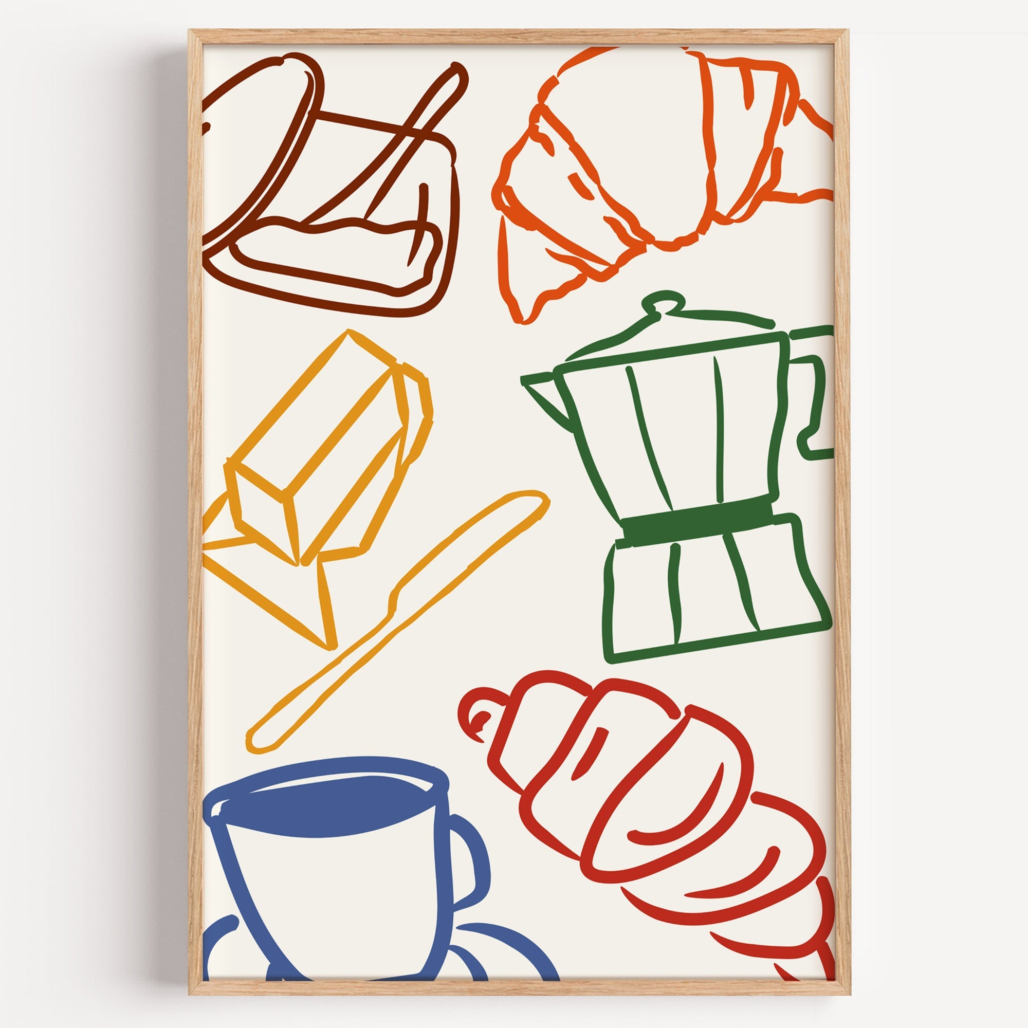 Croissant and coffee doodle print in a light oak frame on a plain white wall