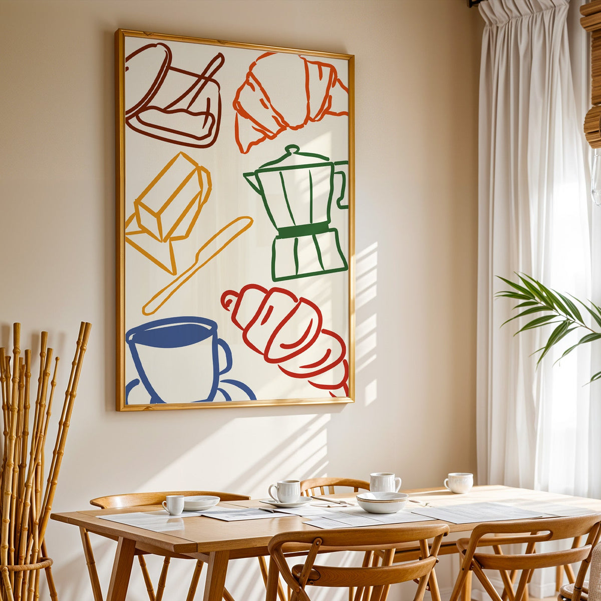 Croissant and coffee doodle print in a gold frame above a sunlit breakfast table