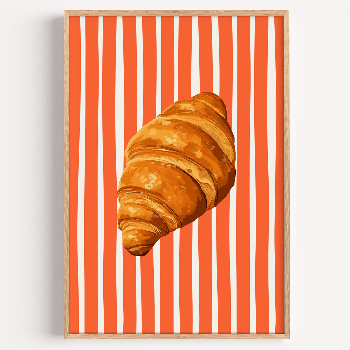 Painted croissant print in a light oak frame on a plain white wall