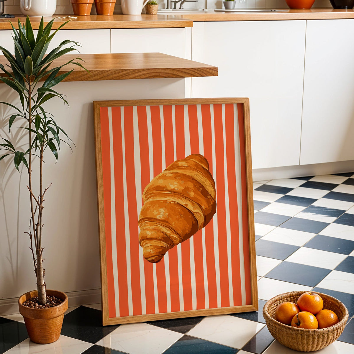 Painted croissant print in an oak frame by a kitchen island and checkered floor