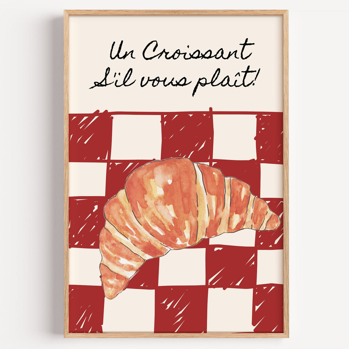 Un Croissant red check print in a light oak frame on a plain white wall