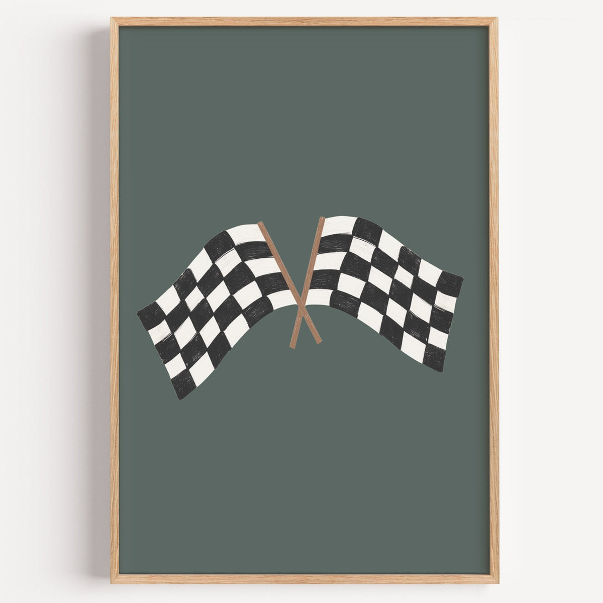 Crossed checkered racing flags nursery print in a light oak frame on a plain white wall