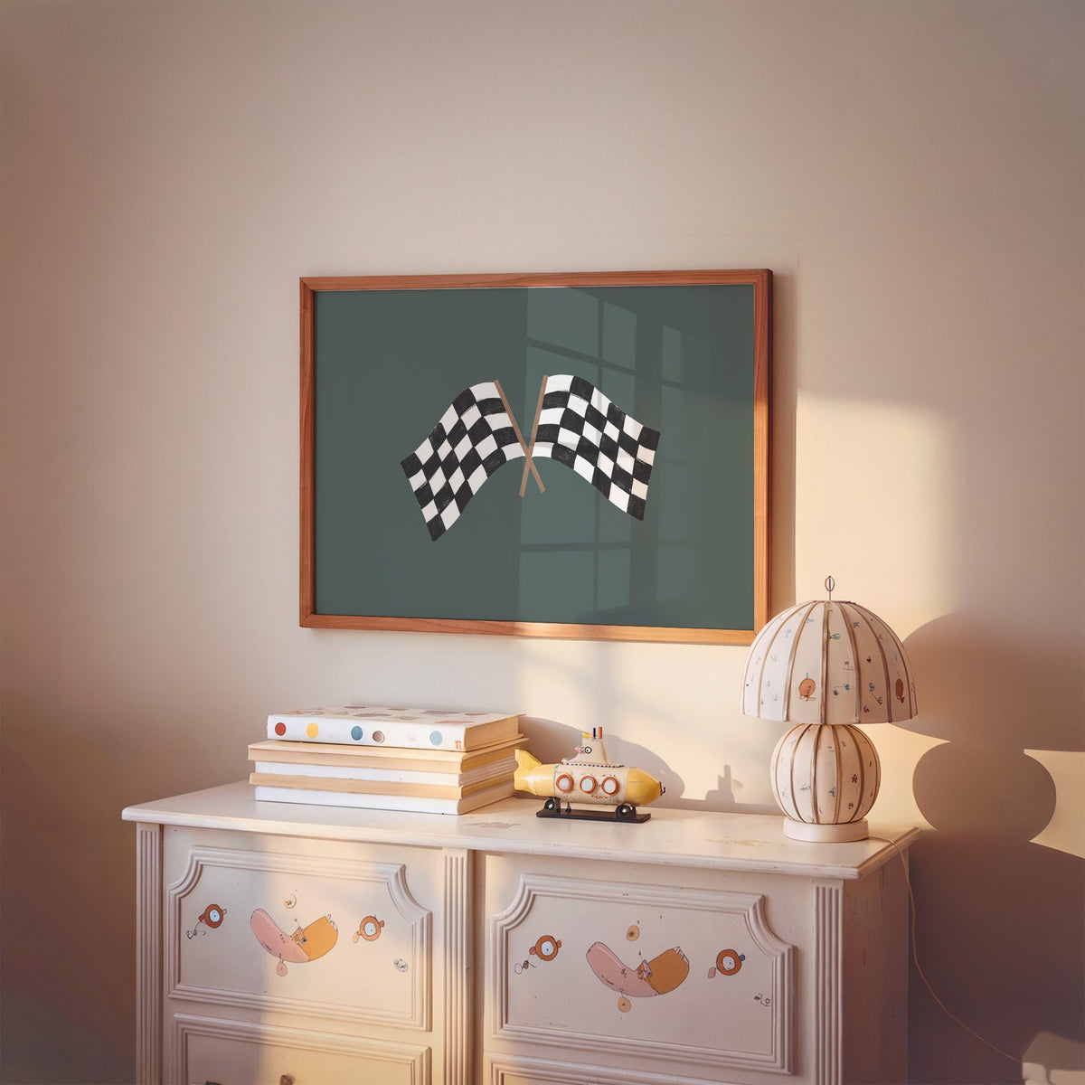 Landscape crossed checkered racing flags nursery print in a cherry wood frame above a painted dresser and lamp
