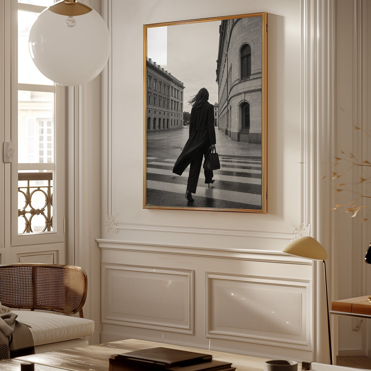 Woman in long black coat on wet crosswalk print shown in a gold frame in a Parisian paneled living room