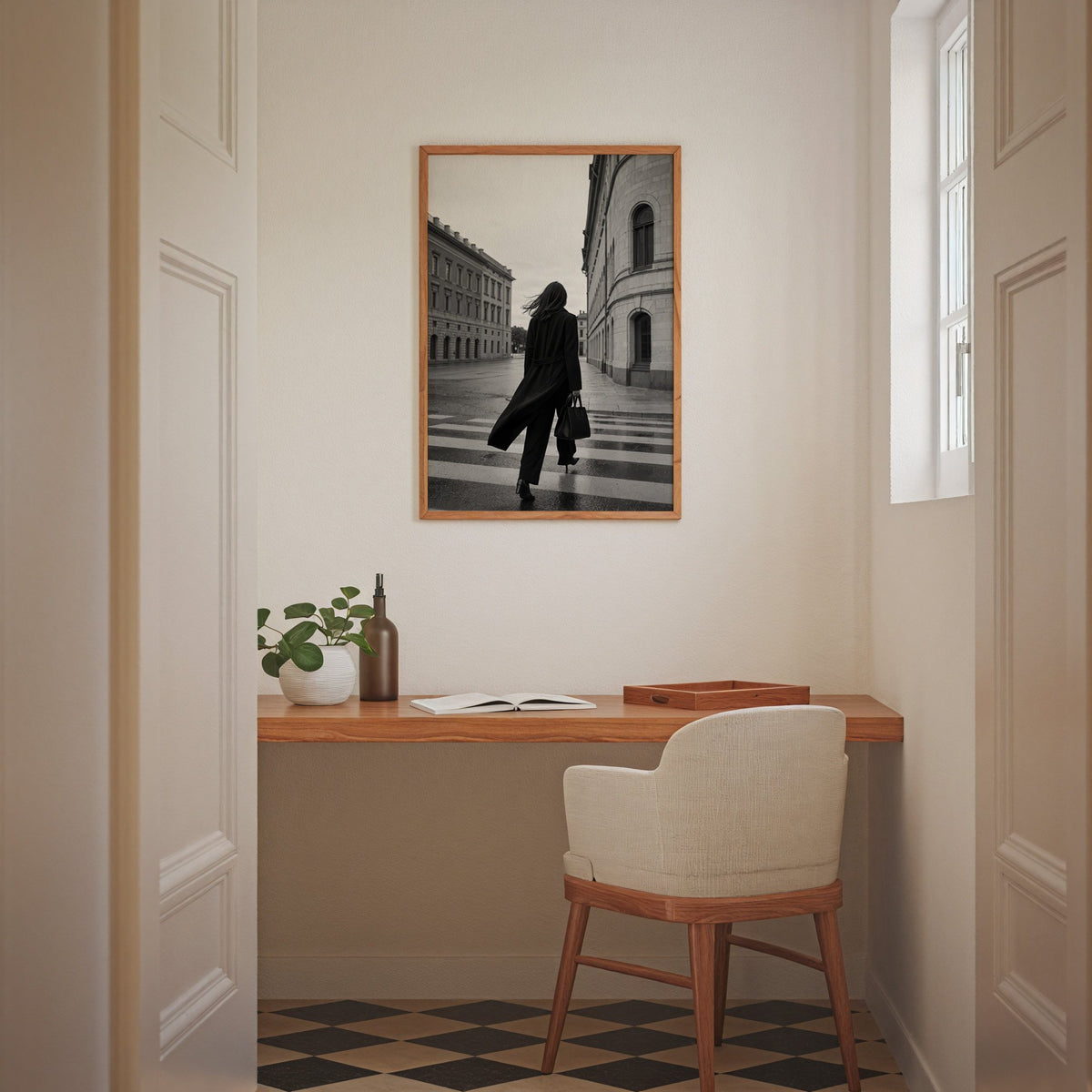 Woman in long black coat on wet crosswalk print in an oak frame above a home office desk nook