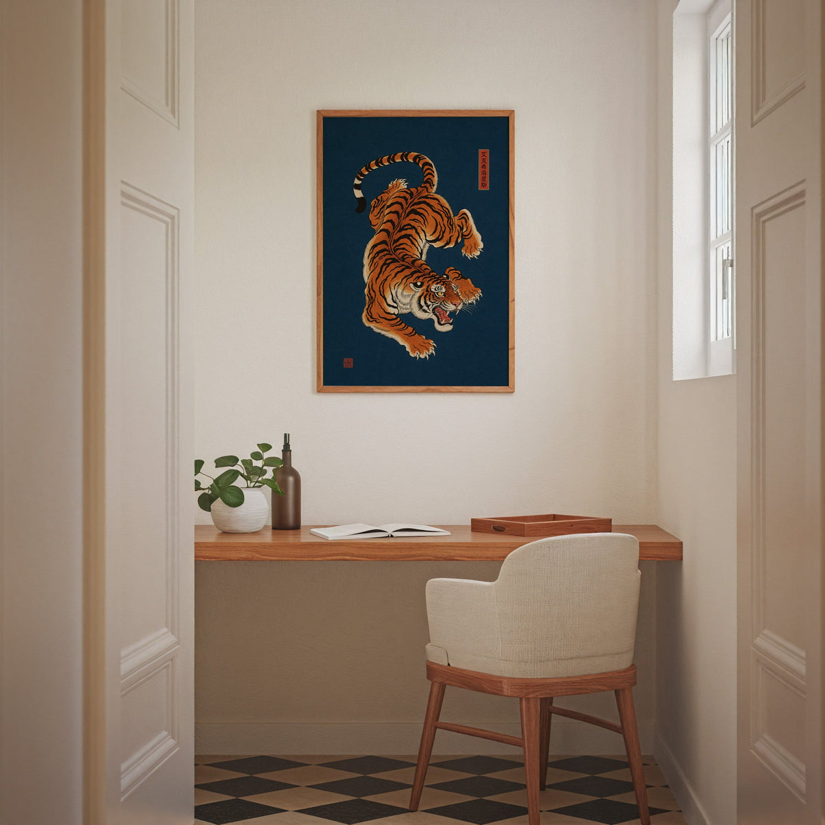 orange tiger on navy blue print in an oak frame above a wall-mounted desk in a home office nook