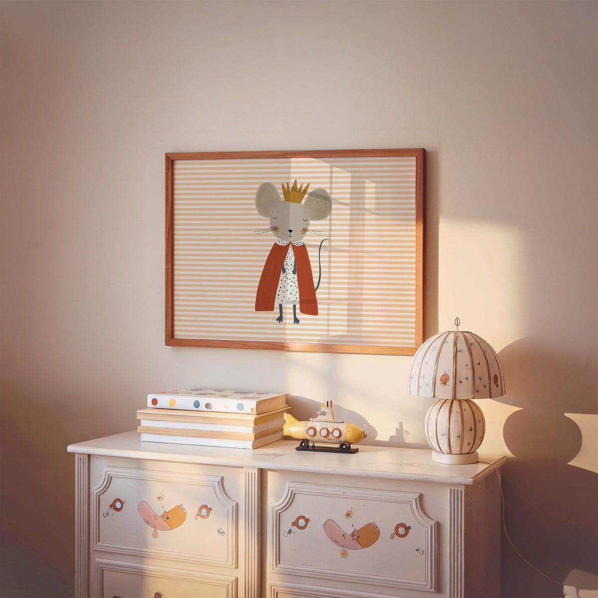 Landscape crowned mouse red cape nursery print in a cherry wood frame above a painted dresser and lamp
