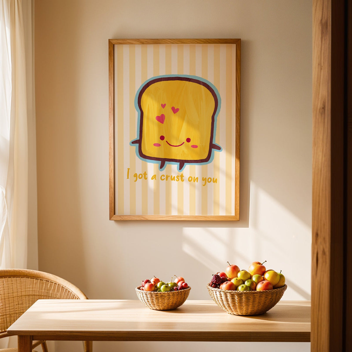 I got a crust on you smiling toast print in an oak frame above a light wood dining table with baskets of fruit