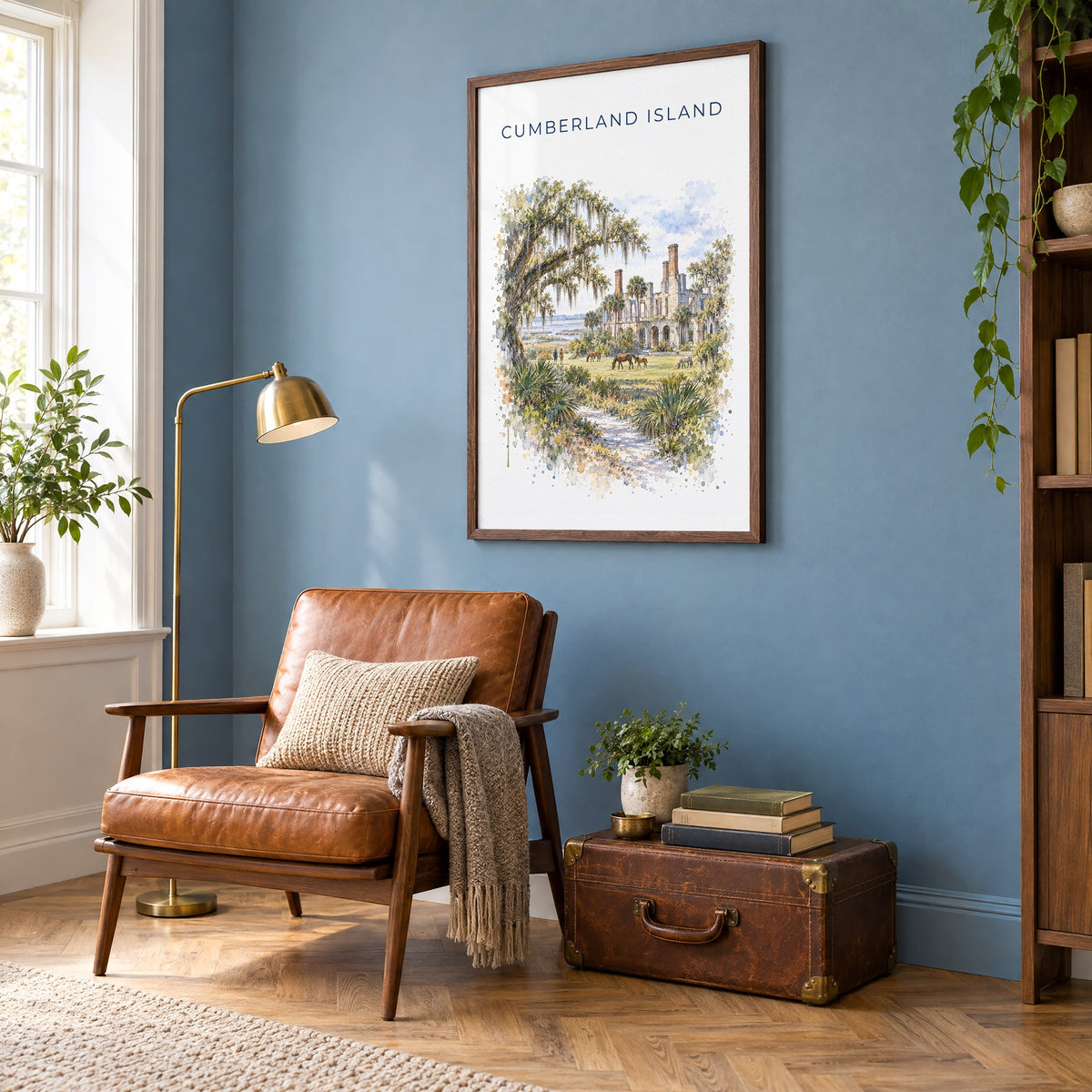 Cumberland Island watercolor print in a walnut frame on a blue wall above a leather armchair in a reading nook
