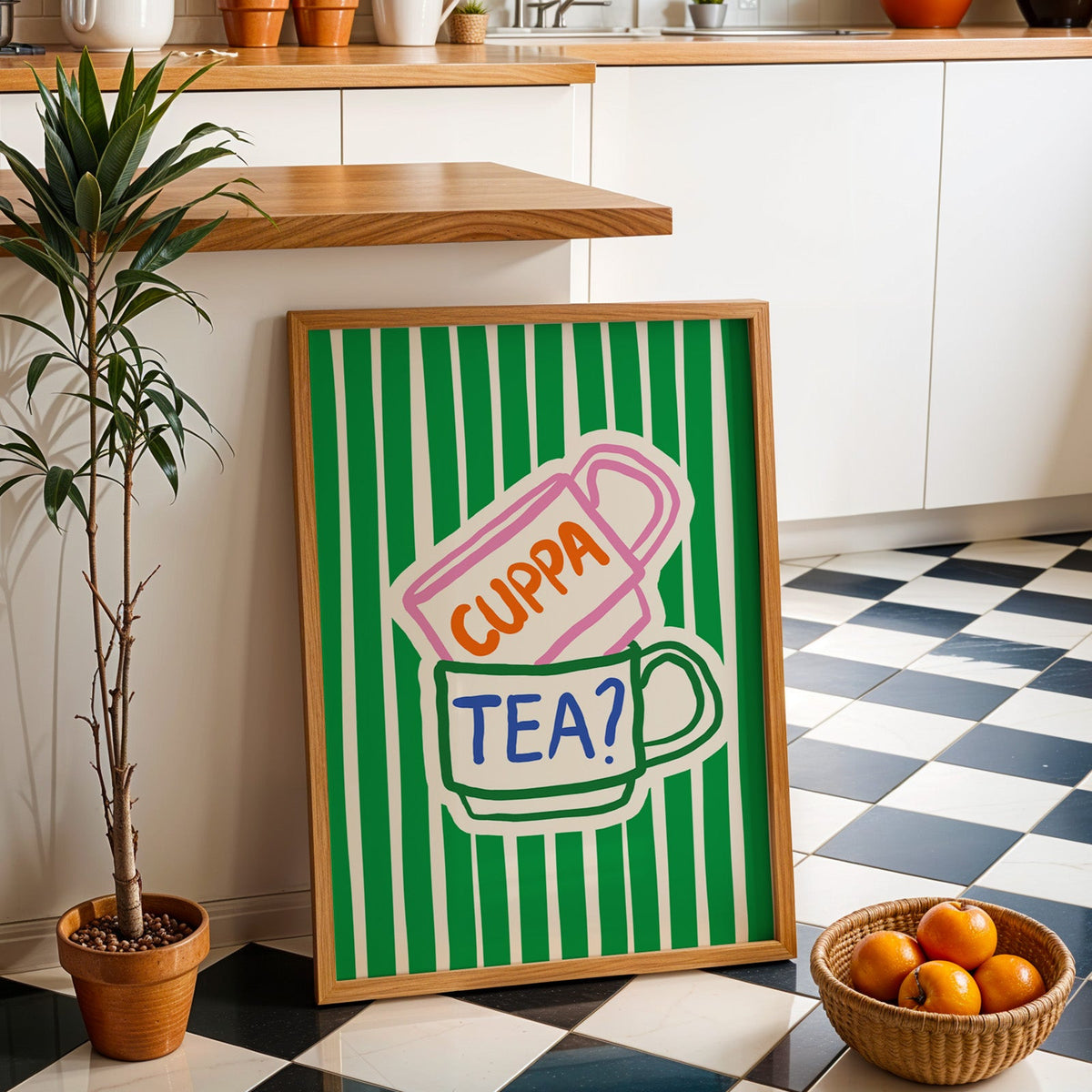 Cuppa tea print in an oak frame by a kitchen island and checkered floor
