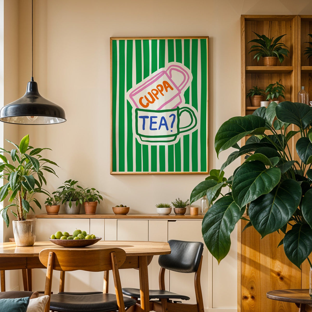 Cuppa tea print in an oak frame above a sideboard in a plant-filled dining room