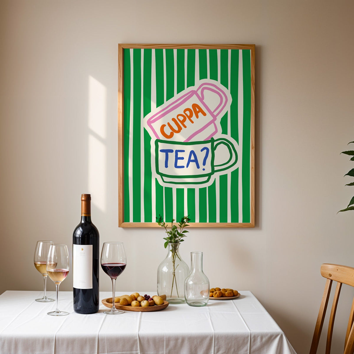 Cuppa tea print in an oak frame above a table laid with red wine and glasses