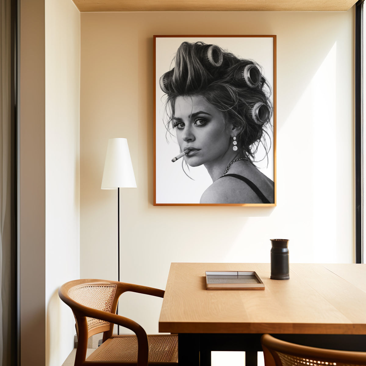Woman in big curlers looking over shoulder print in an oak frame above a dining table and cane chair