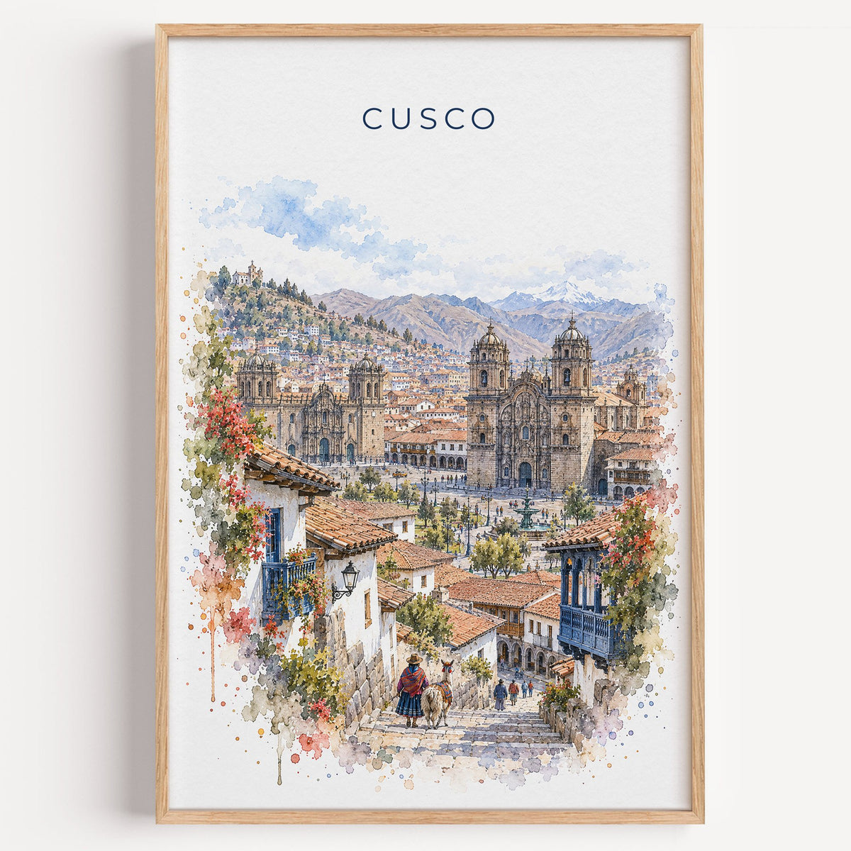 Cusco watercolor print in a light oak frame on a plain white wall