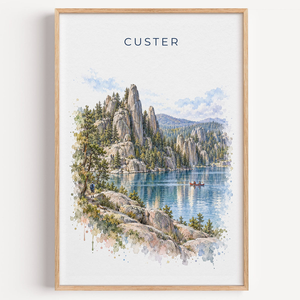 Custer State Park watercolor print in a light oak frame on a plain white wall