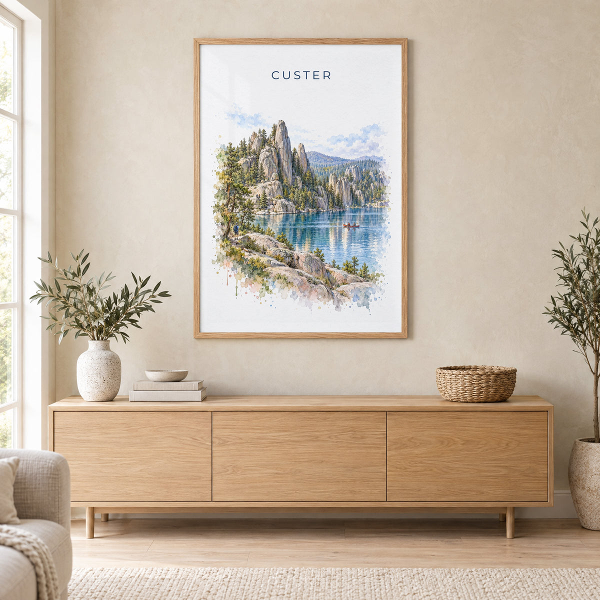 Custer State Park watercolor print in an oak frame above a light wood sideboard in a Scandinavian living room