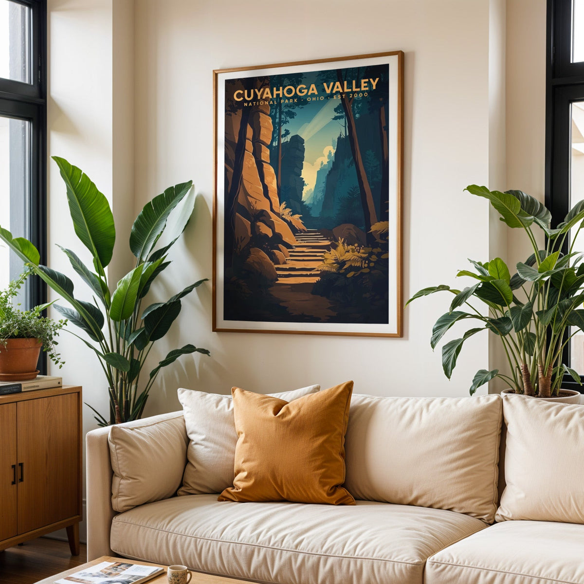 Cuyahoga Valley print in an oak frame above a cream living room sofa with an ochre cushion