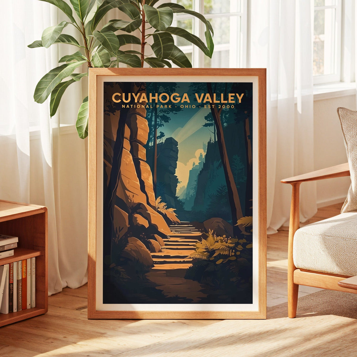 Cuyahoga Valley print in an oak frame by a sunlit window with sheer curtains and a fig plant