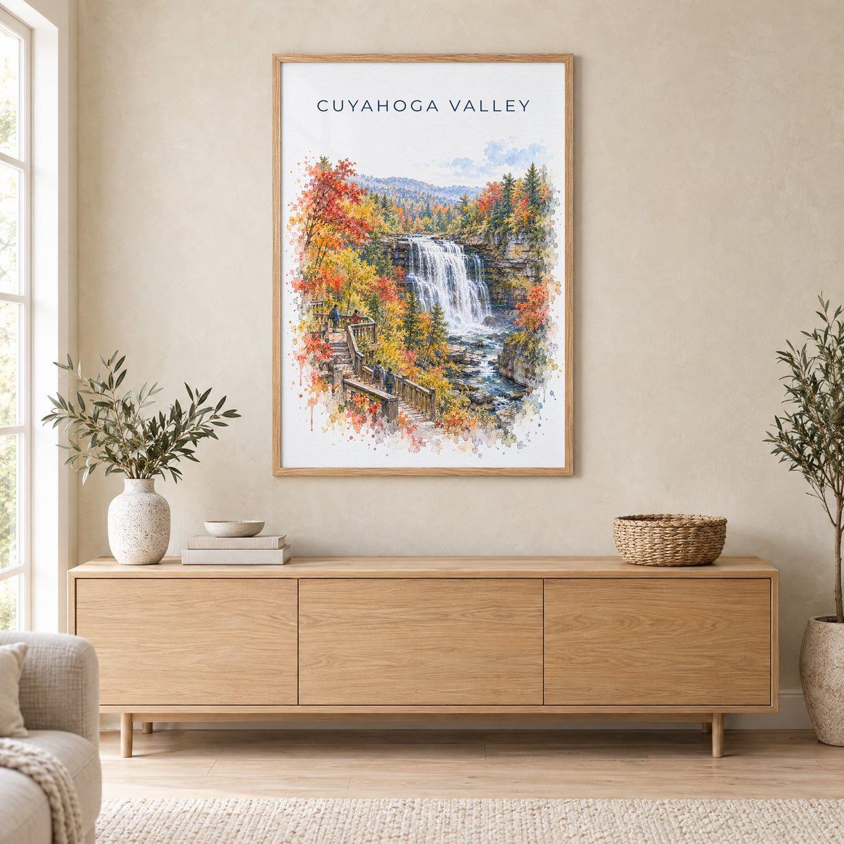 Cuyahoga Valley National Park watercolor print in an oak frame above a light wood sideboard in a Scandinavian living room