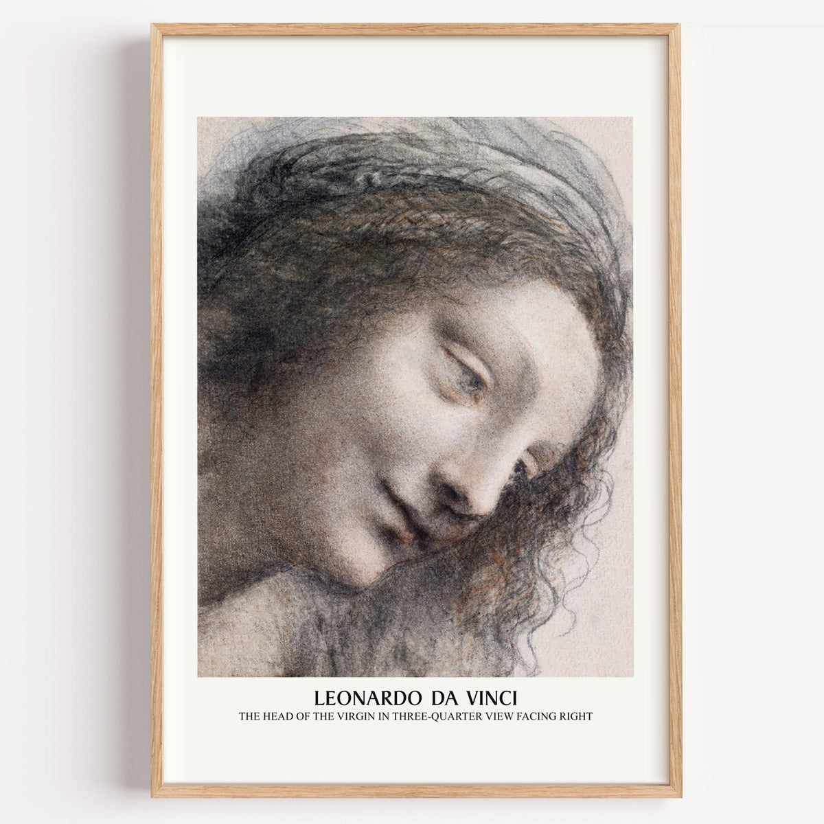 Leonardo da Vinci Head of the Virgin drawing print in a light oak frame on a white wall
