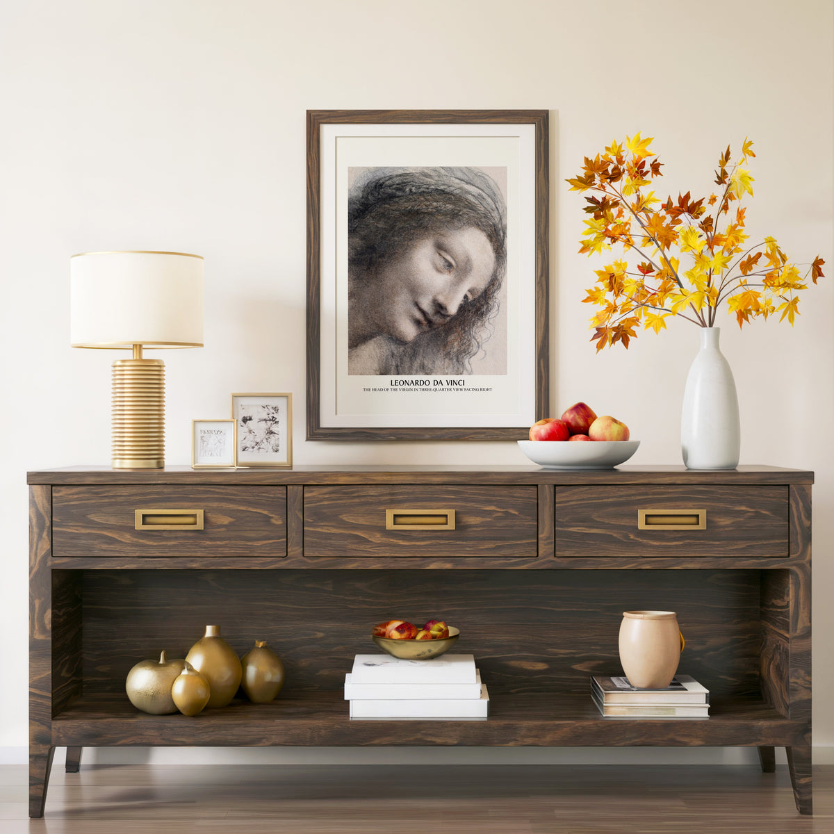 Head of the Virgin print in a walnut frame above a console with autumn branches