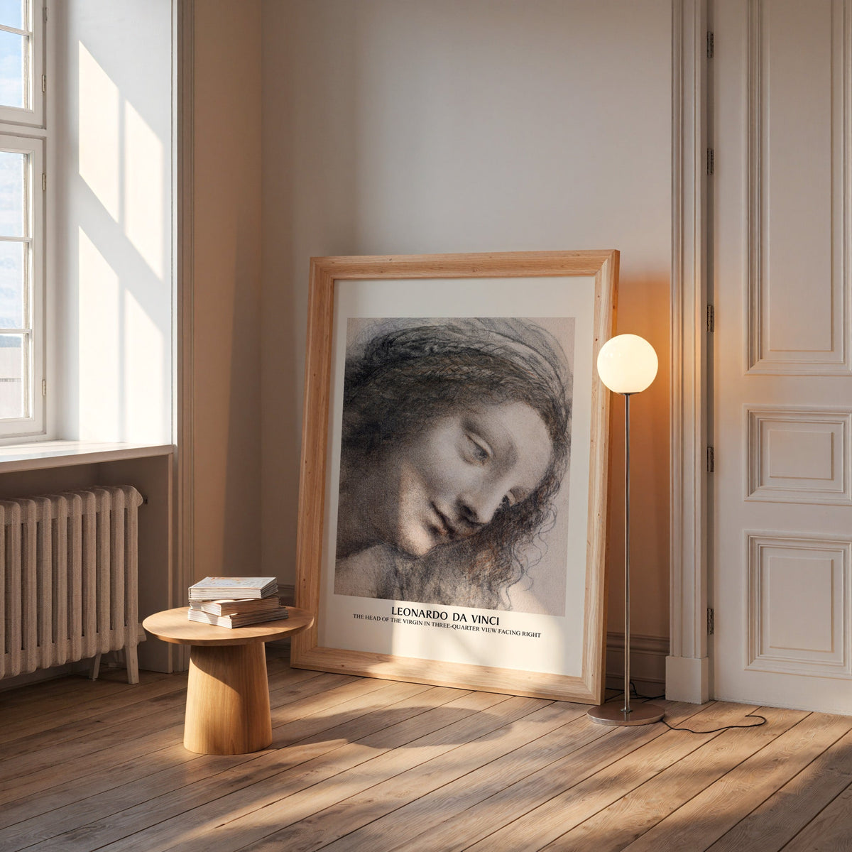 Da Vinci drawing print in a wide pine frame leaning by a sunlit window