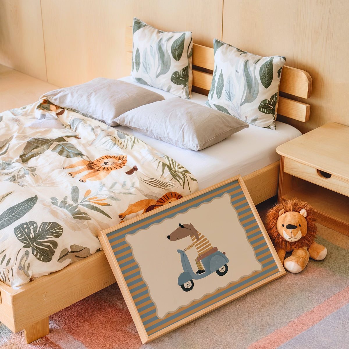 Landscape dachshund on blue scooter nursery print in an oak frame leaning on a kids bed by a lion plush
