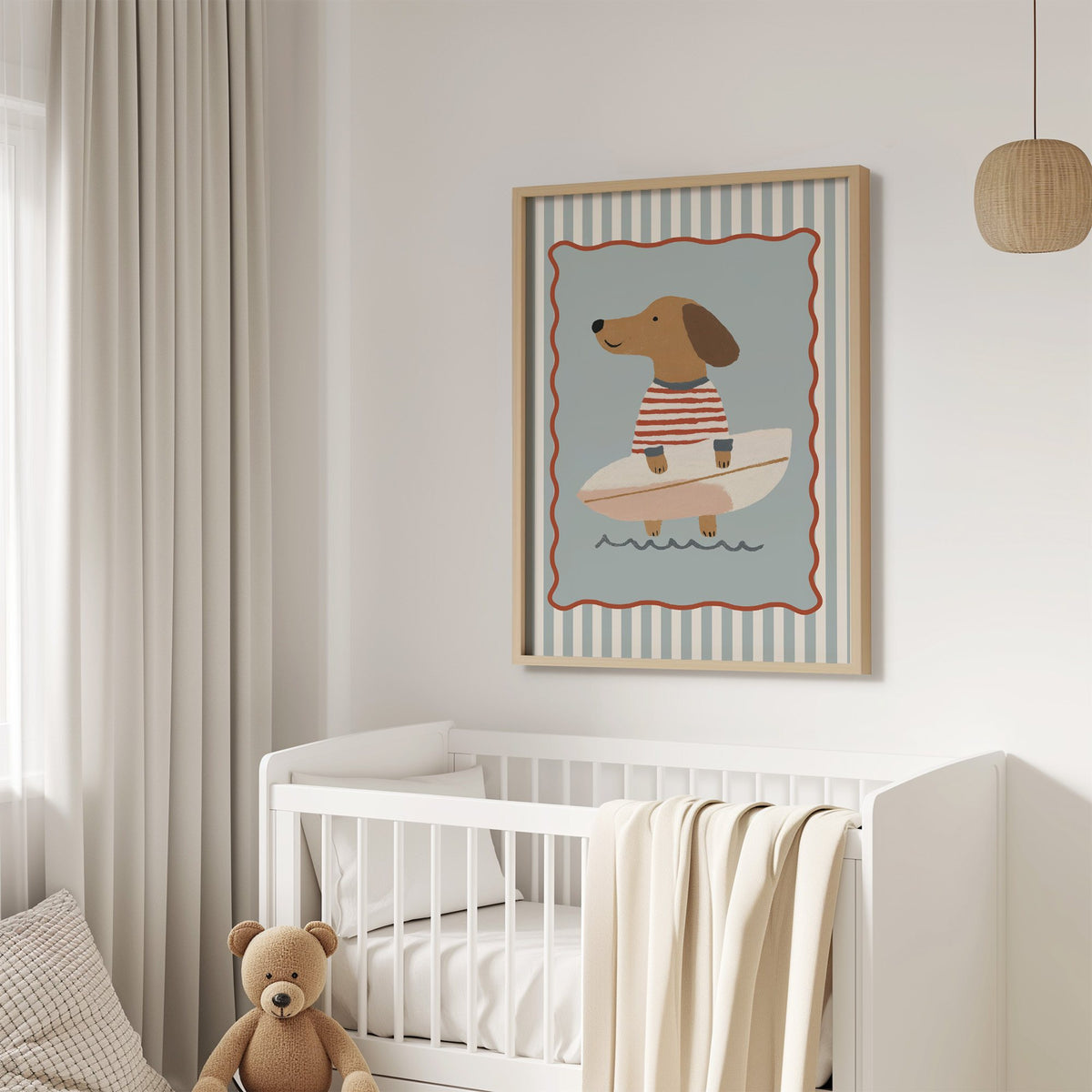 Dachshund holding surfboard nursery print in an oak frame above a white crib with a teddy bear